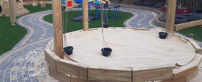Circular sandpit with beige cover